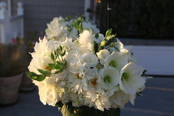 bouquet of white roses and peonies glowing in the sun