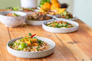 The Khao Soi Yuan Naan that is served on the plate is Khao Soi noodles mixed with minced pork spring onion coriander and chili lime and sesame spicy and sour. noodles chinese food tai yai food