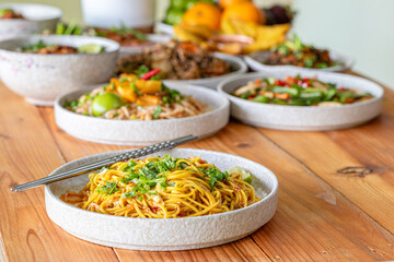 The Khao Soi Yuan Naan that is served on the plate is Khao Soi noodles mixed with minced pork spring onion coriander and chili lime and sesame spicy and sour. noodles chinese food tai yai food