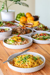 The Khao Soi Yuan Naan that is served on the plate is Khao Soi noodles mixed with minced pork spring onion coriander and chili lime and sesame spicy and sour. noodles chinese food tai yai food