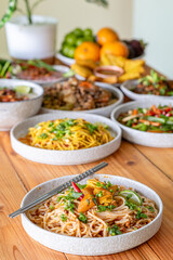The Khao Soi Yuan Naan that is served on the plate is Khao Soi noodles mixed with minced pork spring onion coriander and chili lime and sesame spicy and sour. noodles chinese food tai yai food