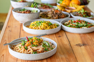 The Khao Soi Yuan Naan that is served on the plate is Khao Soi noodles mixed with minced pork spring onion coriander and chili lime and sesame spicy and sour. noodles chinese food tai yai food