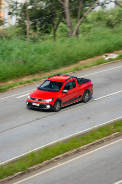 Red Volkswagen Saveiro in city highway, Pickup truck in movement, High Resolution Panning Shot
