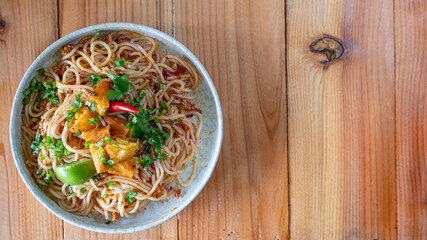 The Khao Soi Yuan Naan that is served on the plate is Khao Soi noodles mixed with minced pork spring onion coriander and chili lime and sesame spicy and sour. noodles chinese food tai yai food