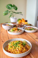 The Khao Soi Yuan Naan that is served on the plate is Khao Soi noodles mixed with minced pork spring onion coriander and chili lime and sesame spicy and sour. noodles chinese food tai yai food