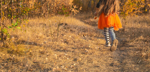 Little girl in scary witch costume at halloween celebrations party in forest. Halloween - traditional american holiday. Kid ready for trick or treat on Halloween night
