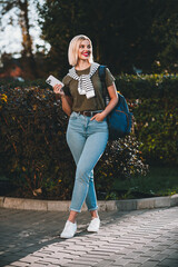 Full length vertical photo of young cheerful lady wonderd hold gadget wear khaki garment tied...