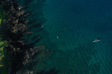 Long Palm Tree shadows on Wailea Maui beach path and shallow reef