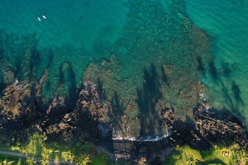 Long Palm Tree shadows on Wailea Maui beach path and shallow reef