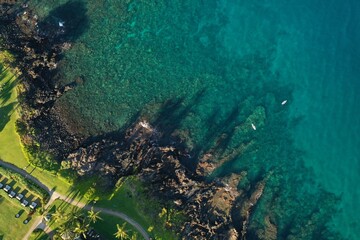 Long Palm Tree shadows on Wailea Maui beach path and shallow reef