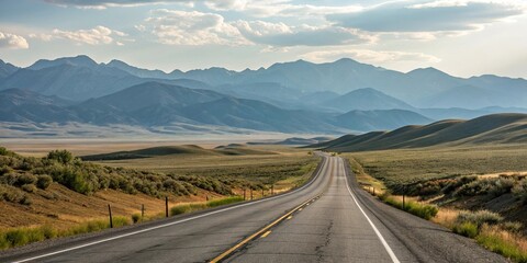 Rolling hills and mountains in the distance along a long empty highway asphalt road, landscape, terrain, hills, outdoors
