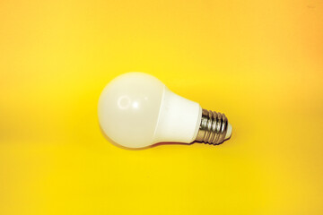 A bulb that is placed flat against a yellow background.