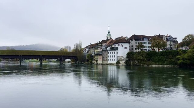 The Covered Historical Wood Bridge Holzbr&uuml;cke over River Aare and Old Town in Autumn in Olten, Canton Solothurn, Switzerland.
