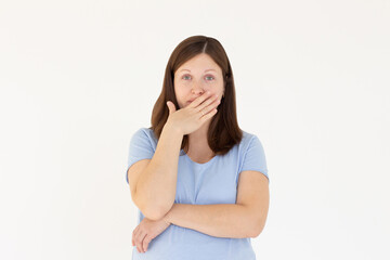 Happy woman closing her mouth with hand going to see surprise prepared by husband standing and smiling in anticipation for something wonderful. Young lady covering mouth with hands