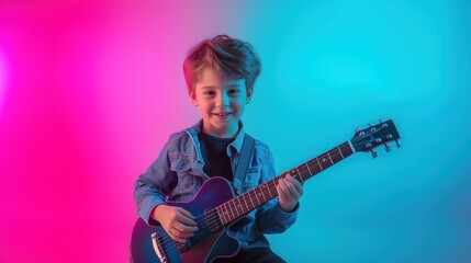 Obraz premium Smiling boy with guitar on neon pink blue background