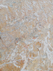 Close-up of natural stone texture with different shades of grey, brown and white. Natural cracks and patterns create a striking and unique texture.
