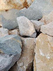 Close-up of natural stone texture with different shades of grey, brown and white. Natural cracks and patterns create a striking and unique texture.