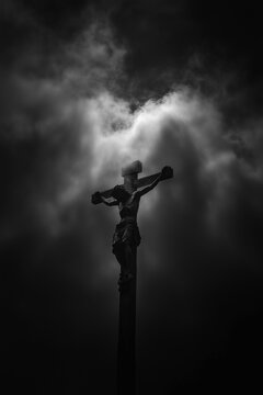 A Silhouette of Jesus on the Cross Against a Darkened Sky