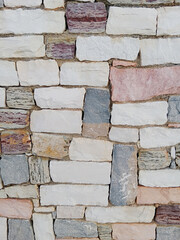 Close-up of natural stone texture with different shades of grey, brown and white. Natural cracks and patterns create a striking and unique texture.