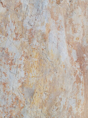 Close-up of natural stone texture with different shades of grey, brown and white. Natural cracks and patterns create a striking and unique texture.