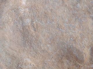 Close-up of natural stone texture with different shades of grey, brown and white. Natural cracks and patterns create a striking and unique texture.