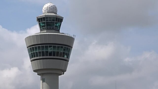 airport control tower (atc) standing against cloudy sky key infrastructure for air traffic management communication static shot atc aviation operations 