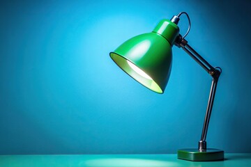 Bright studio lamp with green illumination on blue background