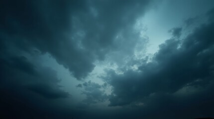 Obraz premium A dramatic image of a dark, cloudy sky filled with swirling storm clouds, capturing the intensity and mood of an impending storm