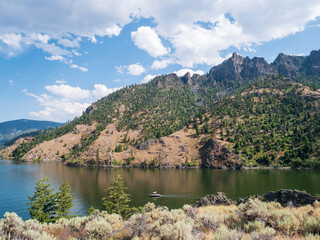 A boat floats on lake wallace in mountains in idaho