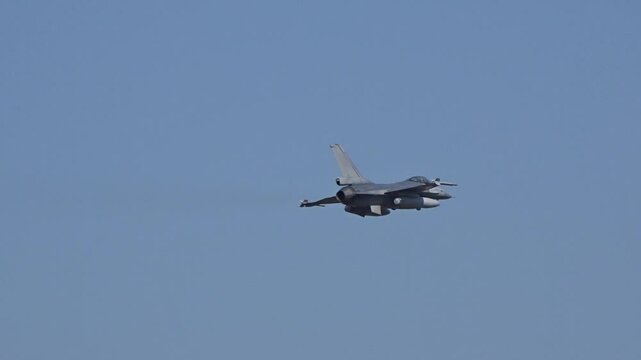 military fighter jet performing high speed flyby after takeoff from airbase during combat operations for potential action close up view air force aircraft flying take off base 