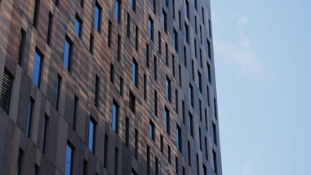 Modern glass office scyscraper buildings beautifully reflecting the clear blue sky in an urban environment