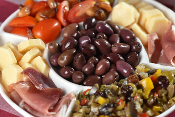 portion of olives with cheese cherry tomatoes and parma ham snack healthy food vegan salad