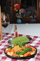 codfish typical Portuguese dish baked cod with onion garlic peppers and potatoes rustic Portuguese food salted fish cooked olive oil