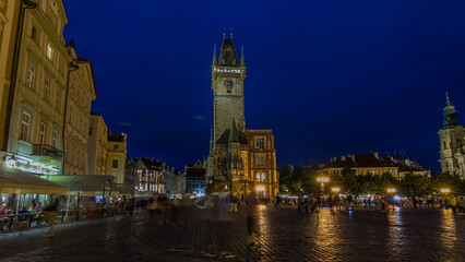 Fototapeta premium Prague Old Town Hall at Night timelapse hyperlapse with unrecognizable tourists walking