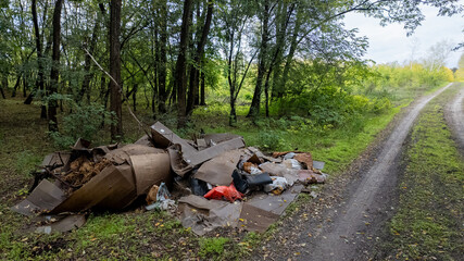 Pile of rubbish dumped in a forest creates environmental pollution problem, highlighting the need for Earth Day awareness efforts