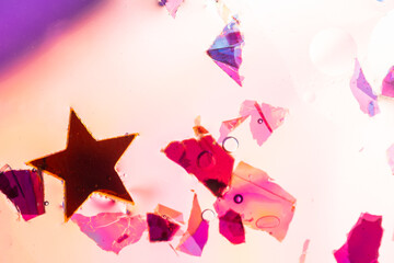 Abstract star and particles floating on colorful background