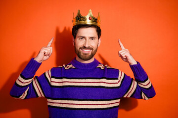 Photo portrait of handsome young guy point king crown dressed stylish striped purple garment...