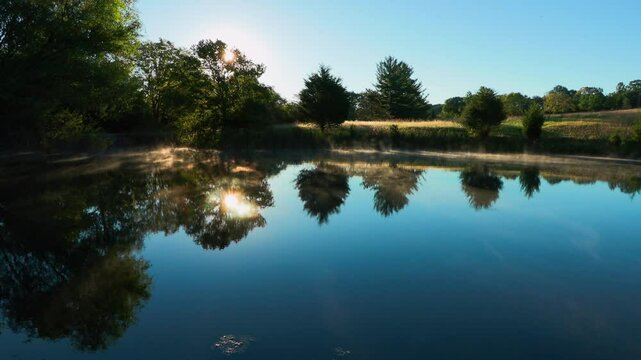 A fishing line is cast into a still pond on a farm in Southern Ohio in the early morning. Ambient sounds of fishing, birds and faint traffic.