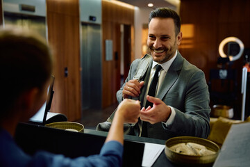 Happy businessman checking in at gym.