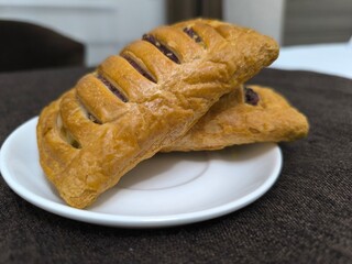 Close-up of puff pastry filled with sweet fruit filling.