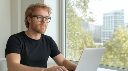 Obraz na płótnie Canvas Concentrated man working on laptop in contemporary office, admiring city view and brainstorming project strategy