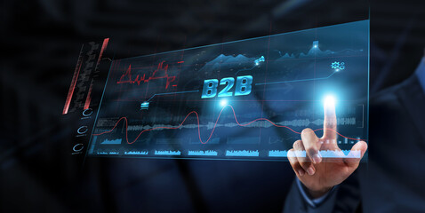 B2B (Business to Business): Businessman analyzes data strategy with graph on digital screen....