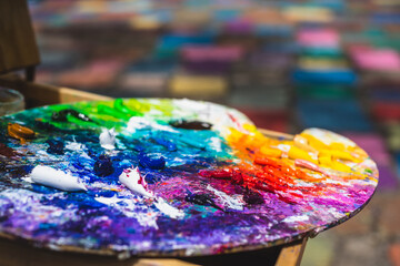 Artist's paint palette with colorful rainbow paints and paint tubes