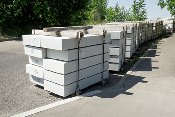 Tile blocks on pallets lie on the road. Сoncrete slabs on pallets.