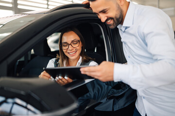 Couple in car enjoying technology access through a tablet