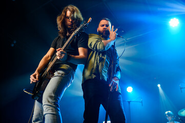 Fototapeta premium Rock band performing live on stage with guitarist and singer