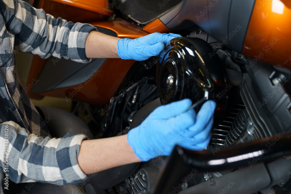 Poster skilled hands working on a motorcycle engine in a garage workshop space
