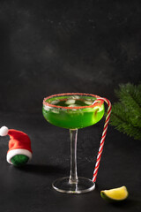 Xmas Green Punch in glass decorated sugar rim on black table make of cool lime sherbet. Tasty drink...