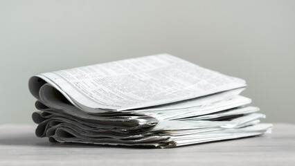 Pile of newspapers stacks on table