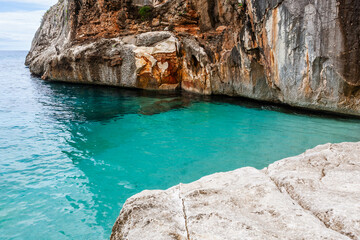 Cala Goloritze. Crystal clear Mediterranean sea and cliffs of Gulf of Orosei. Emerald sea at...